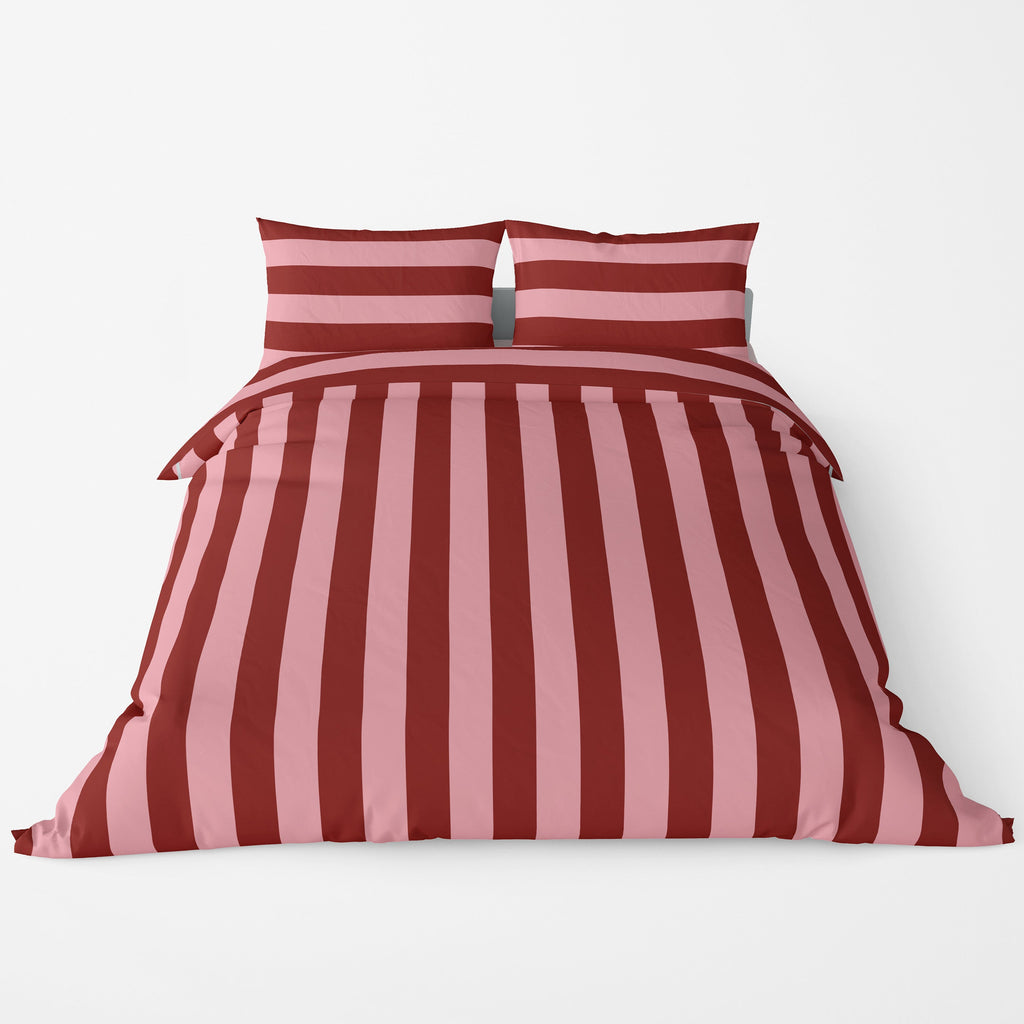 Red and pink striped bedding set on a white background