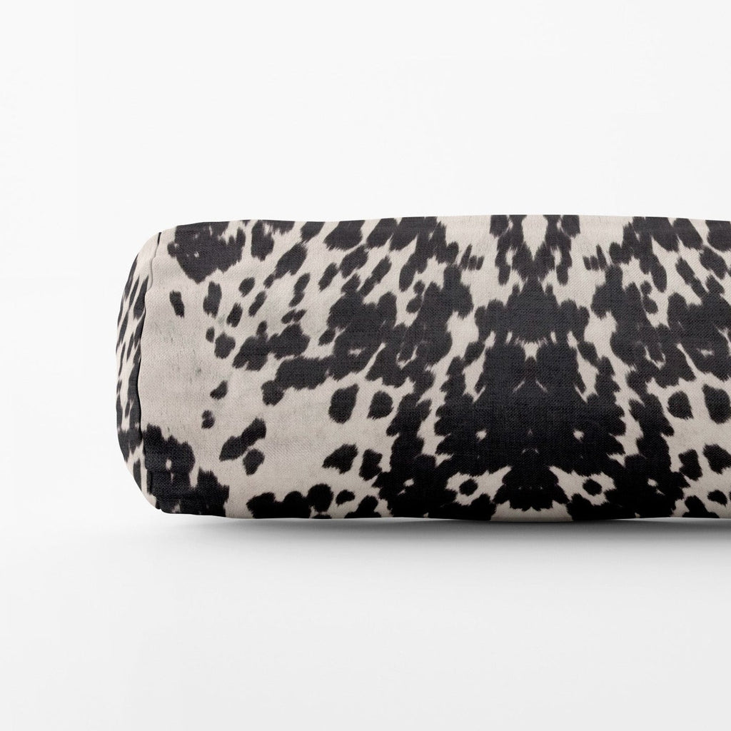 Black and white patterned cylindrical object on a white background