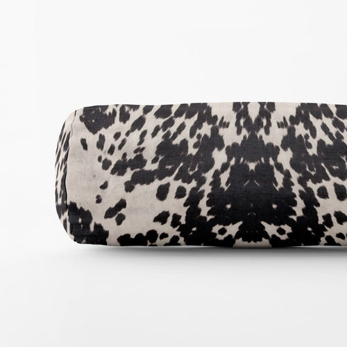 Black and white patterned cylindrical object on a white background